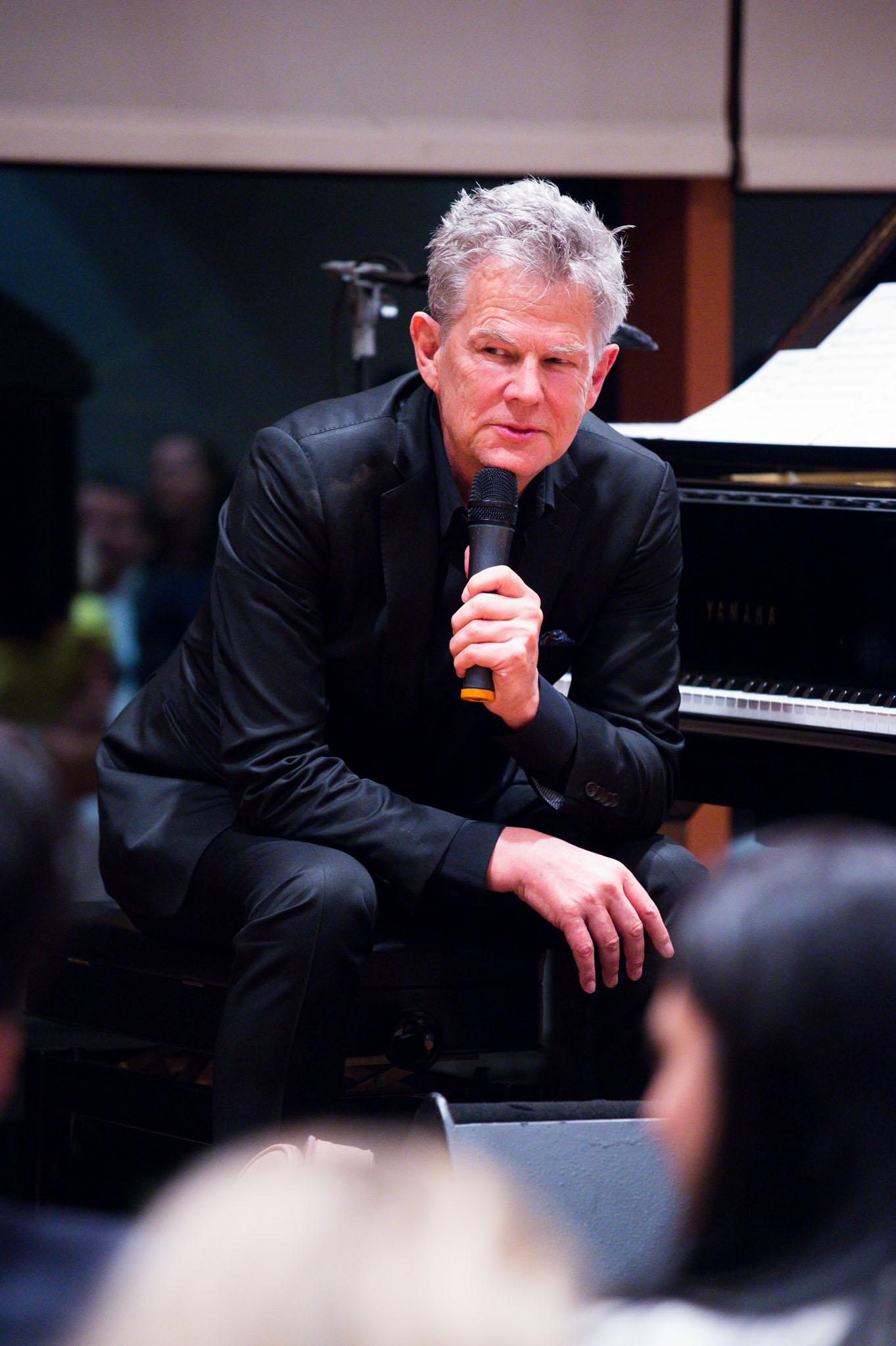 Painist speaking to audience at a concert